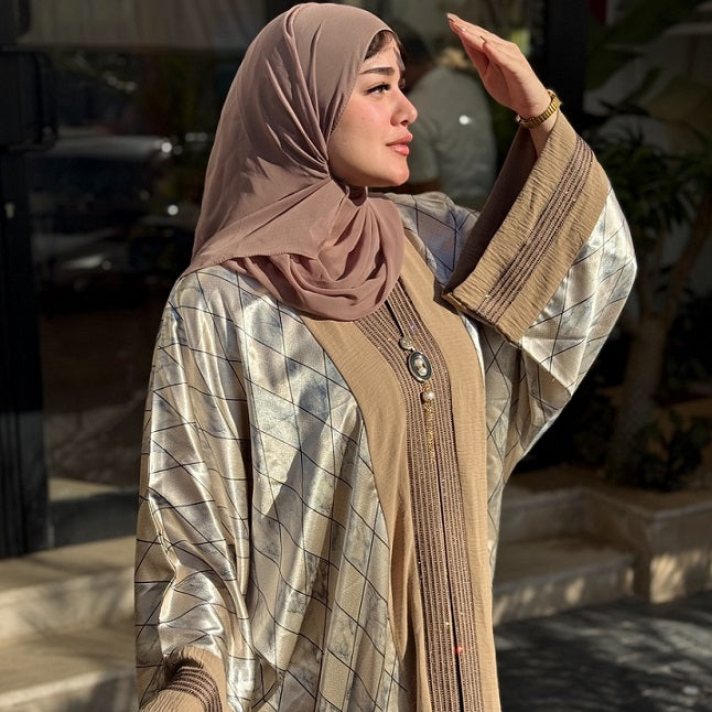 Woman wearing a hijab and traditional outfit outdoors
