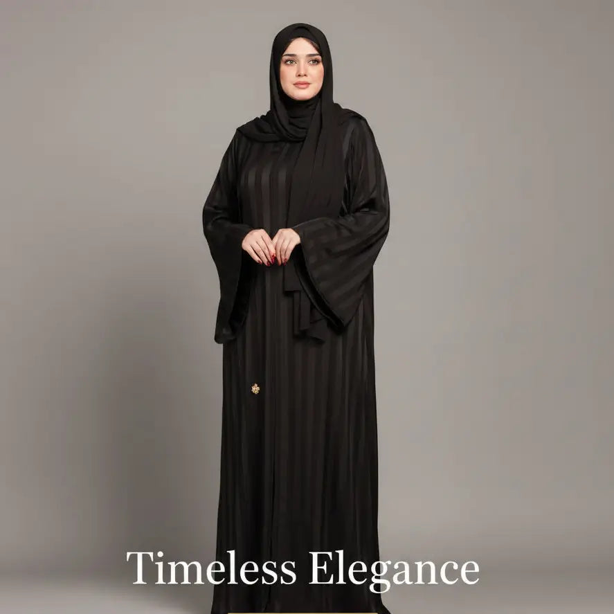 Woman wearing a black abaya with 'Timeless Elegance' text on a gray background